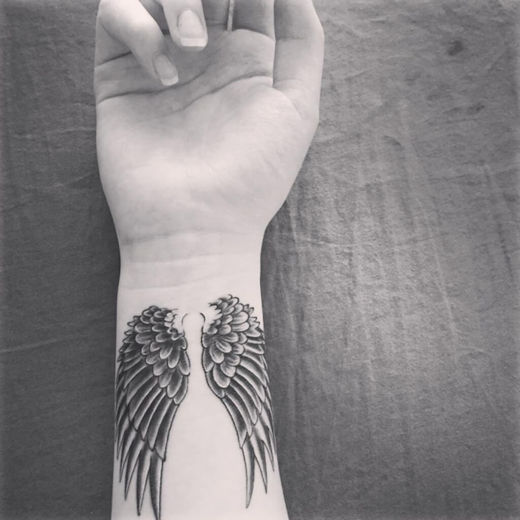 angel wings tattoo on wrist