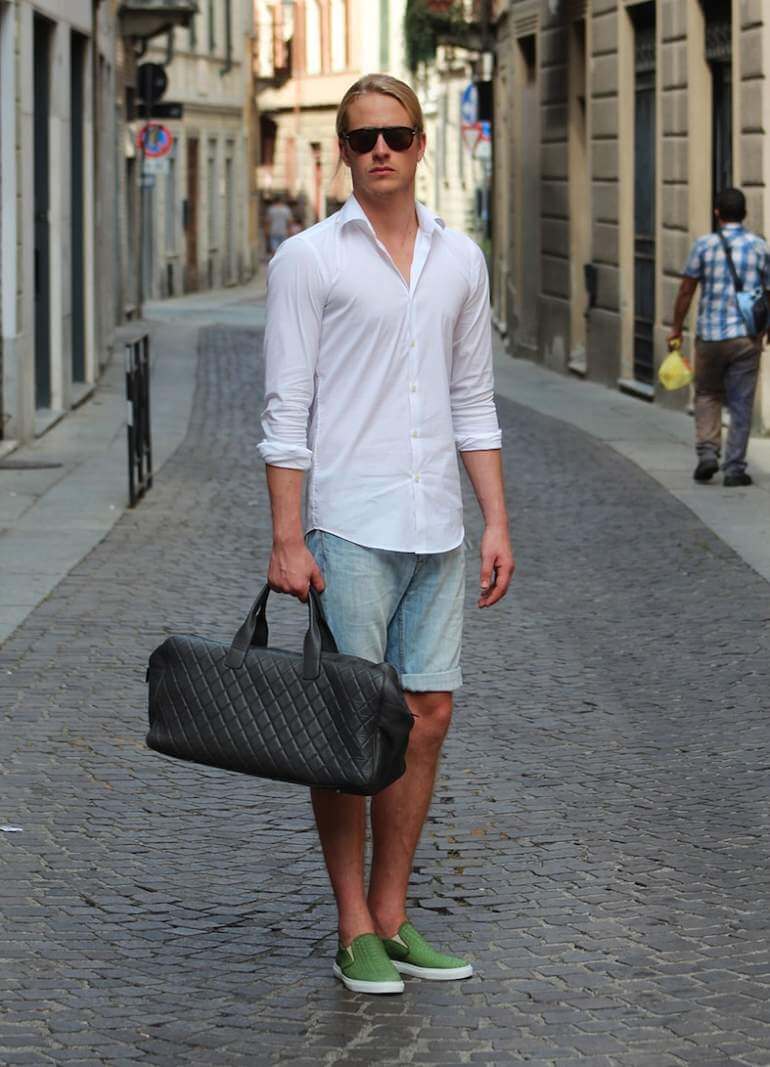 a men with denim short and carrying bag