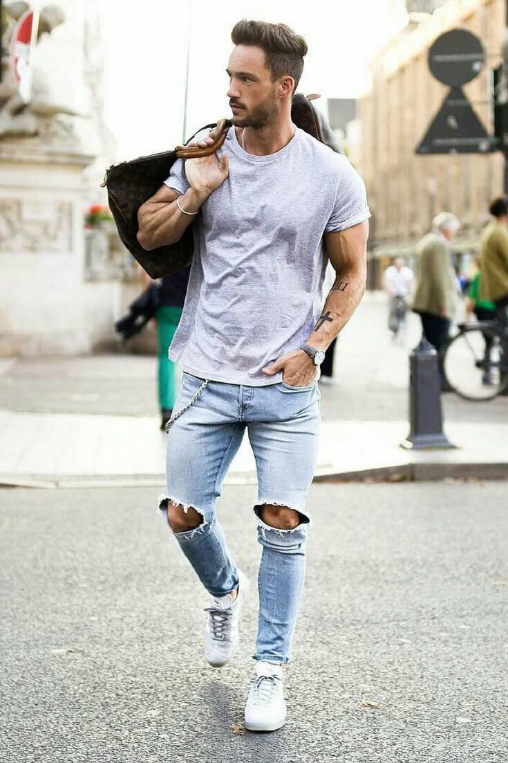 A man walking down the street with a bag in his hand
