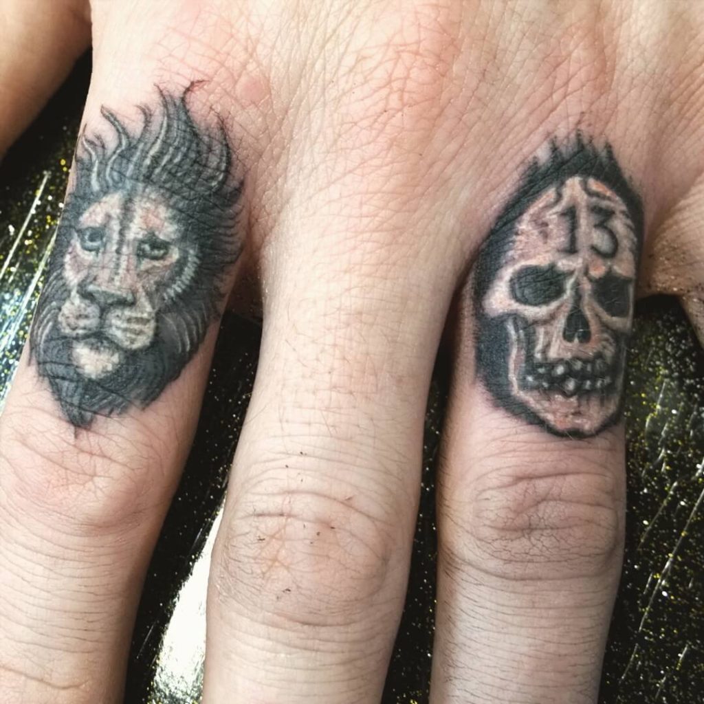  Lion And A Skull finger tattoos