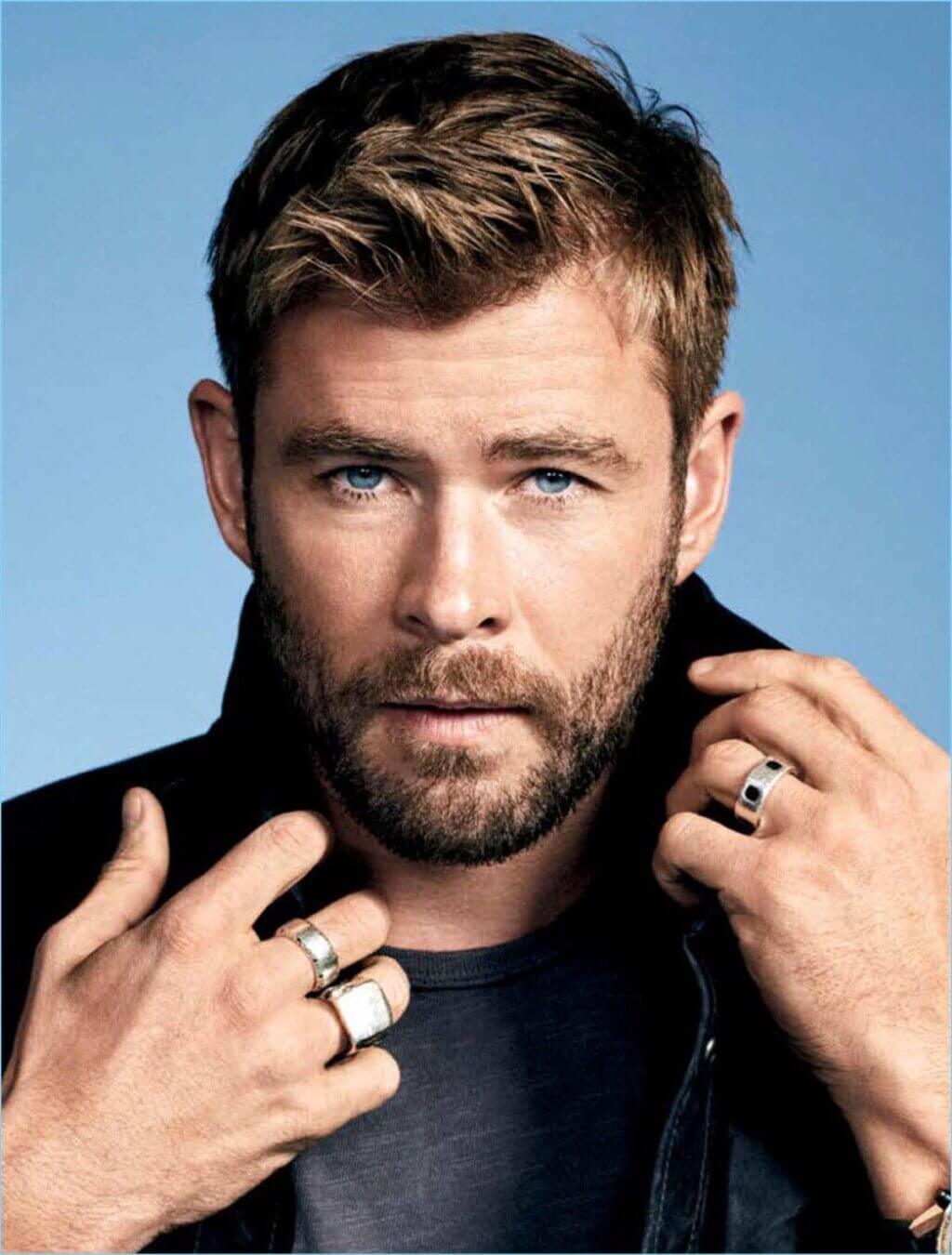 Chris Hemsworth Short Hairstyles  with a beard and a ring on his finger 