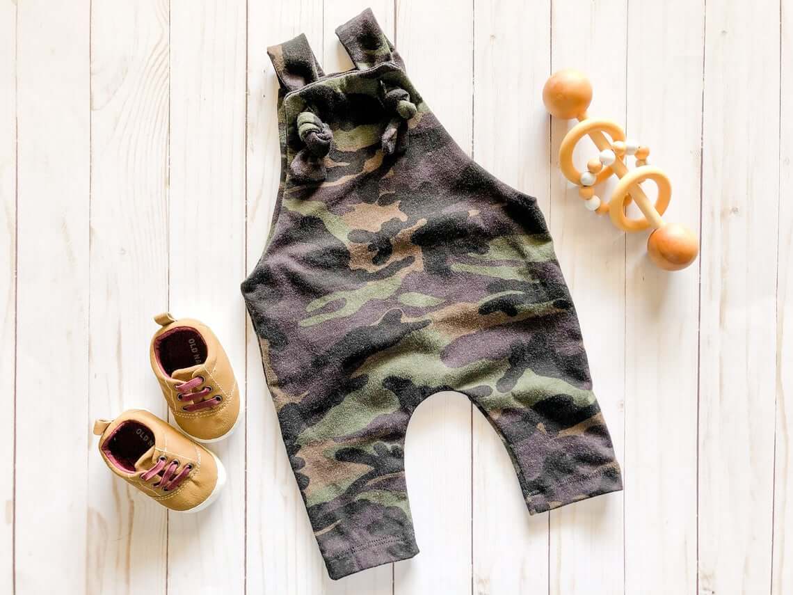 pair of baby shoes and Camo Print outfit