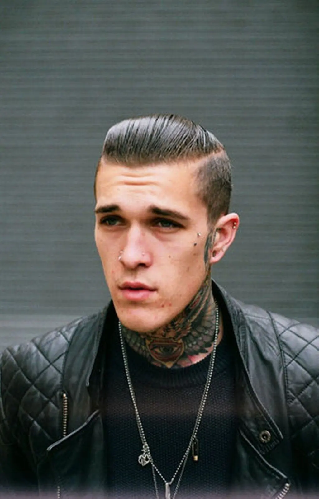 A man with a tattoo on his neck and a leather jacket with Punk Hairstyles