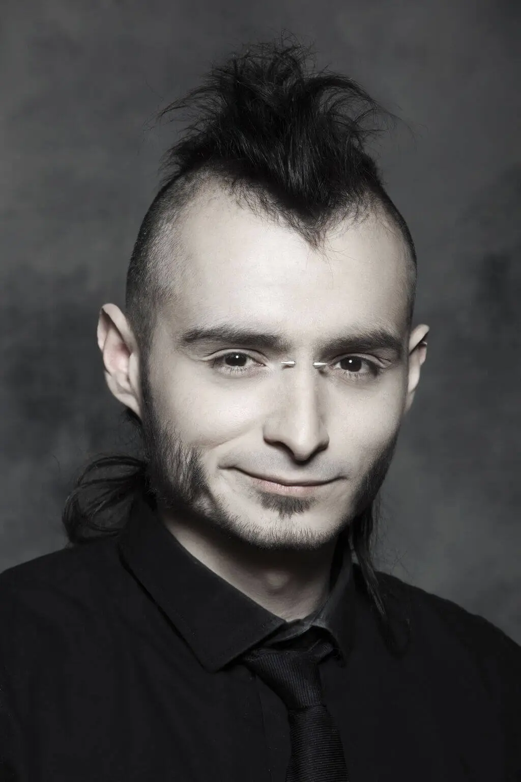 A man with Punk Hairstyles wearing a black shirt 