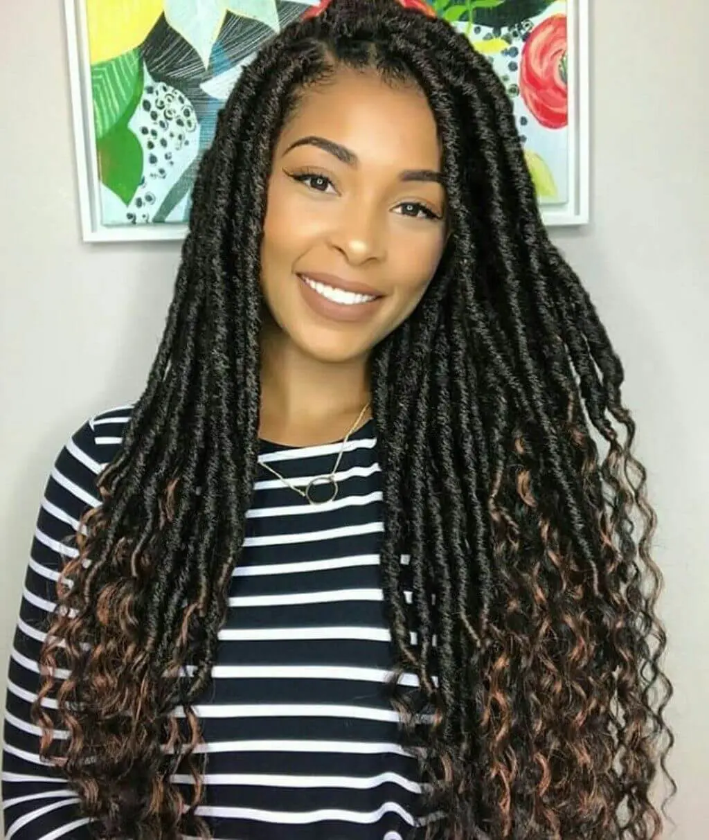 A woman with long, curly Goddess Braids Hairstyle