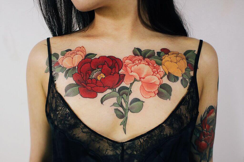 Red, pink and yellow flower female breast tattoos designs