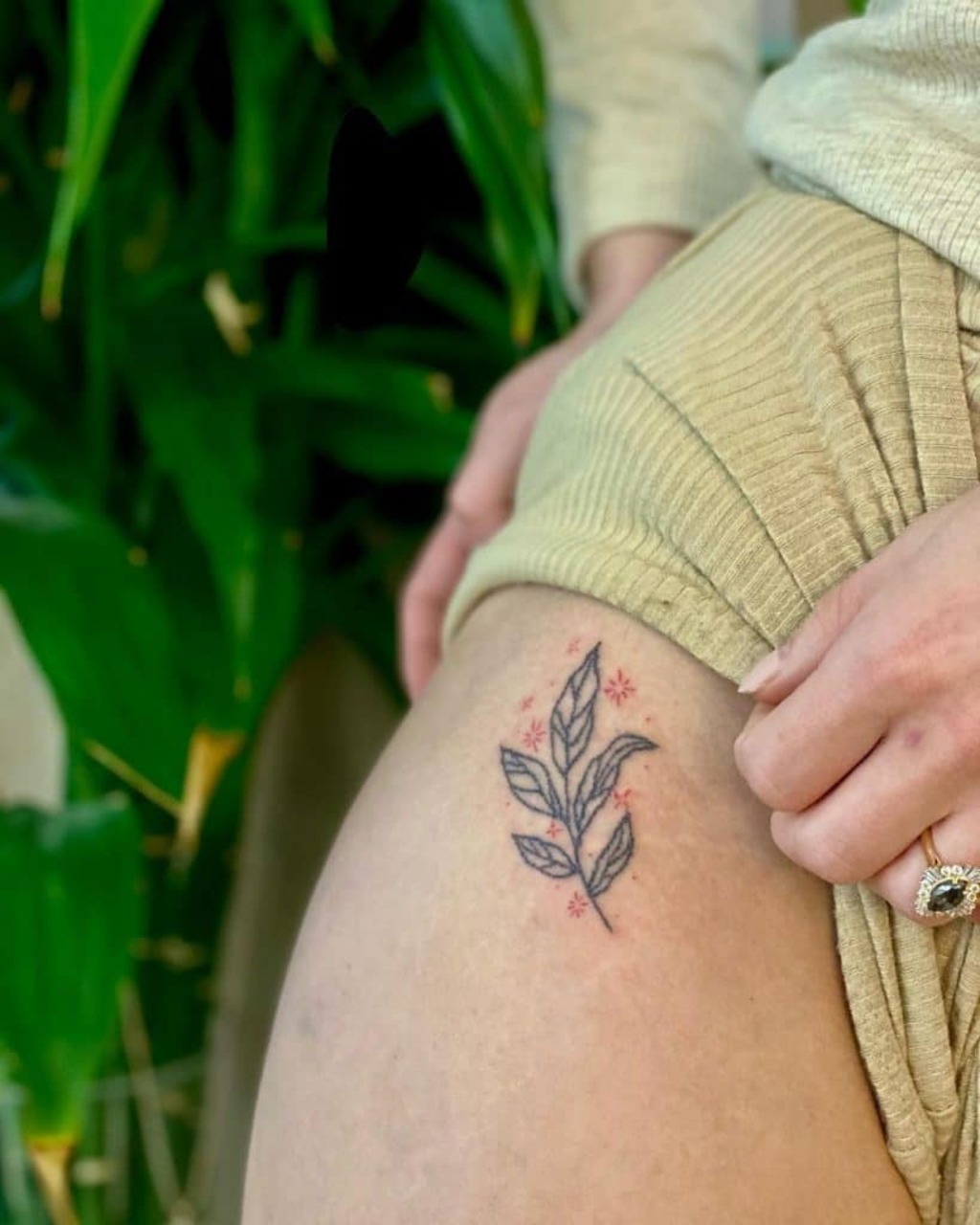 Women with a tattoo on her thigh
