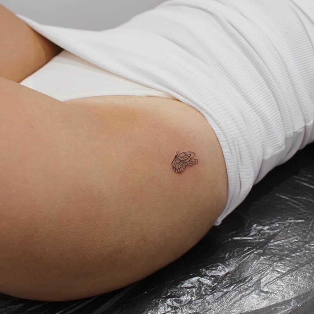 A woman with a small Butterfly tattoo on her Hip
