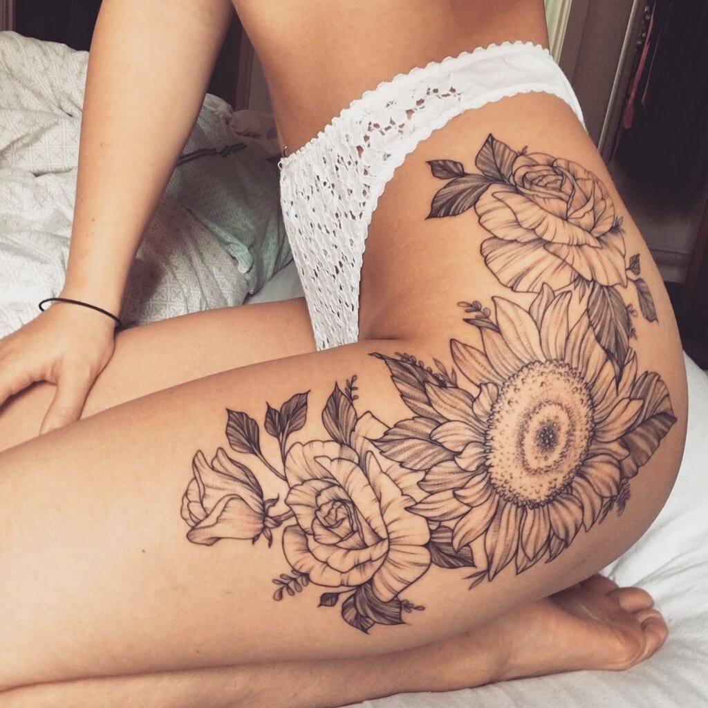 A woman with a sunflower tattoo on her thigh
