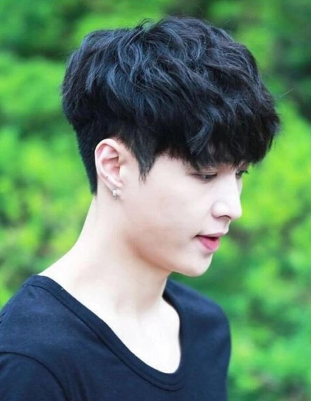 A man with black hair and a black shirt
