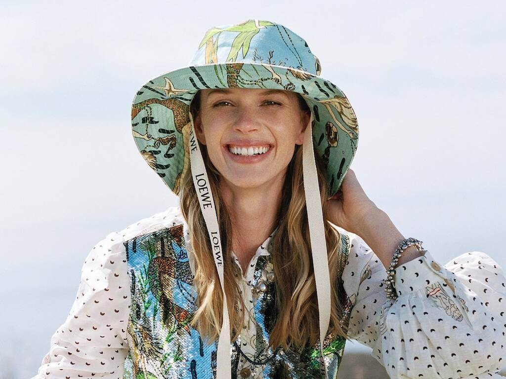 A woman wearing a hat and smiling 
