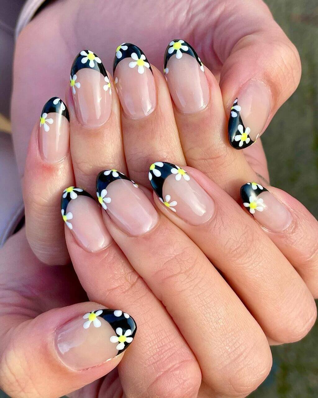 A woman's hands with black and white flowers design
