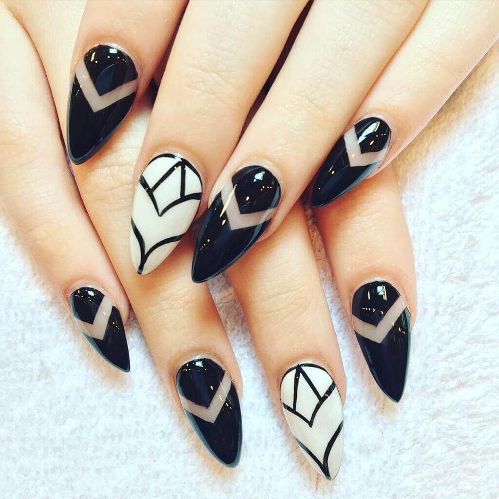 A woman's nails with black and white designs

