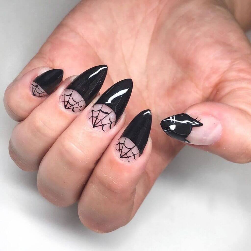A woman's hand with a black and white nails
