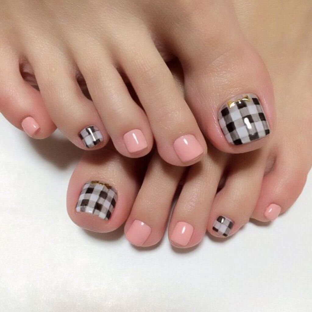 A woman's feet with a checkered design on it

