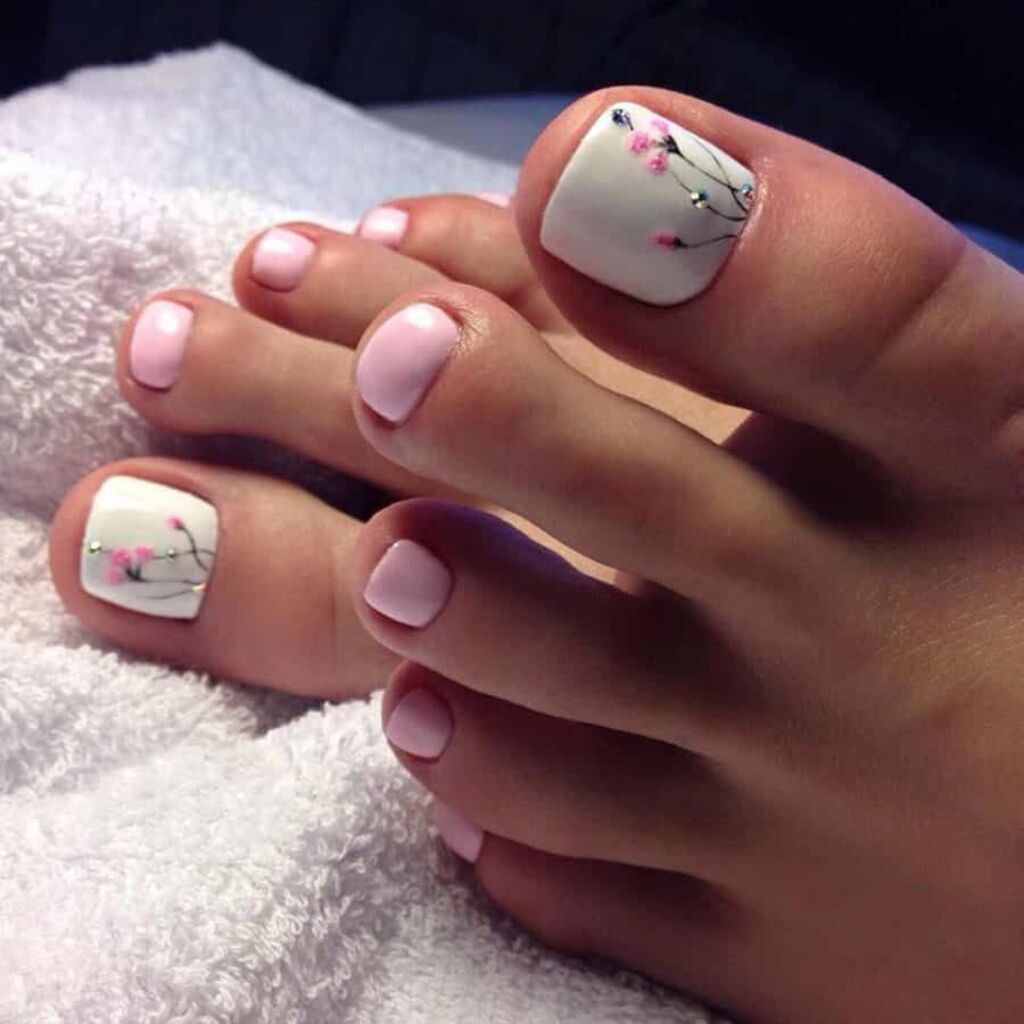 A woman's feet with pink and white flowers on them
