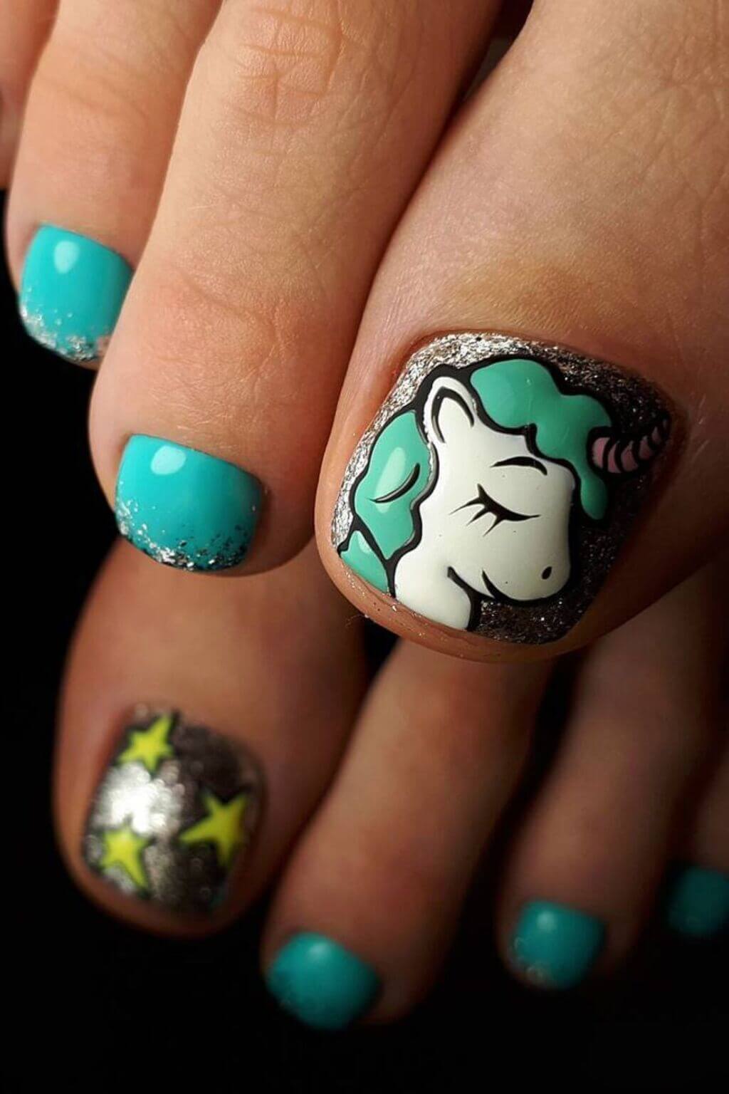 A woman's toe with a unicorn on it
