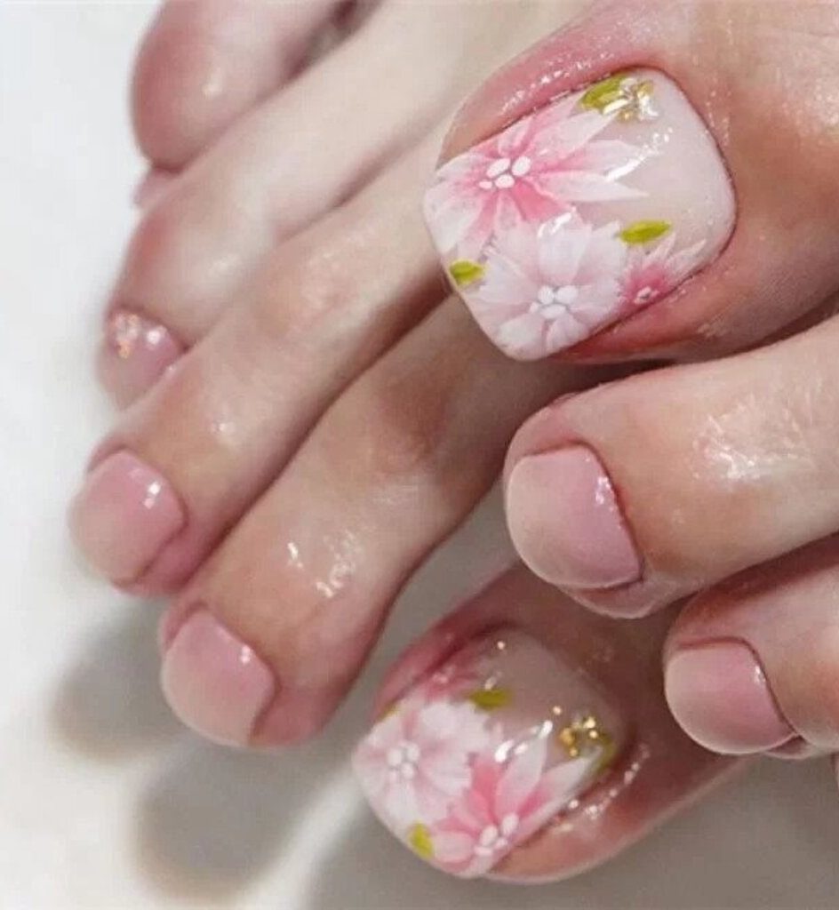 women's feet with flowers on them
