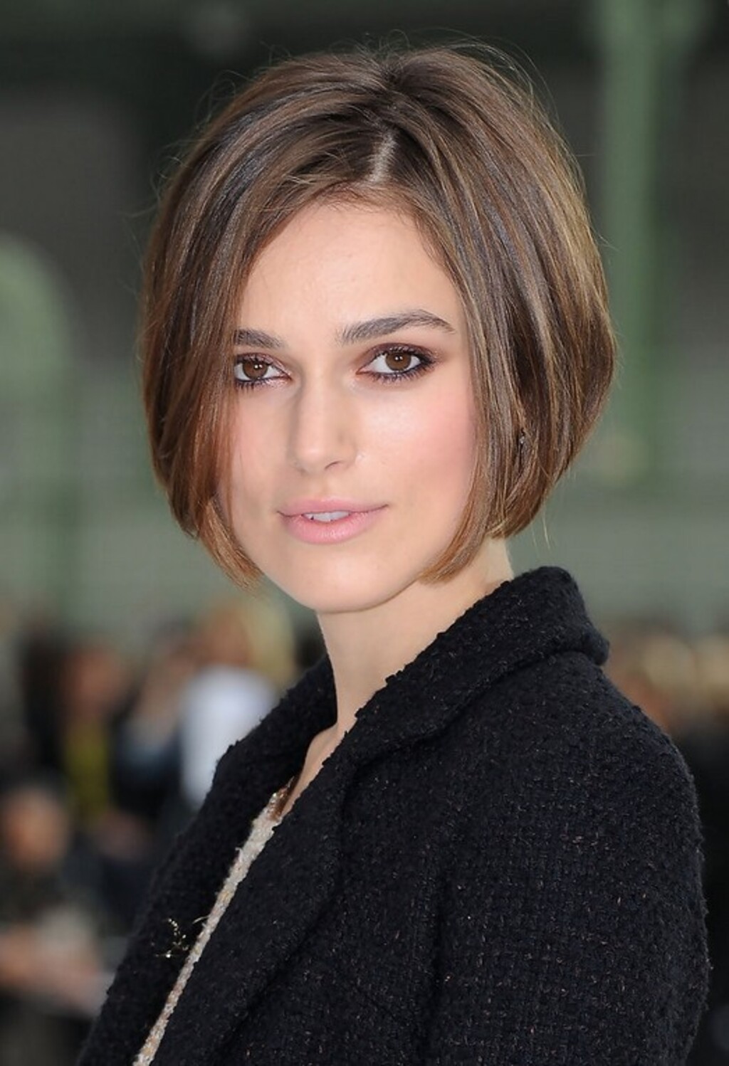 a women with funky short stacked bob hairstyle wear black jacket