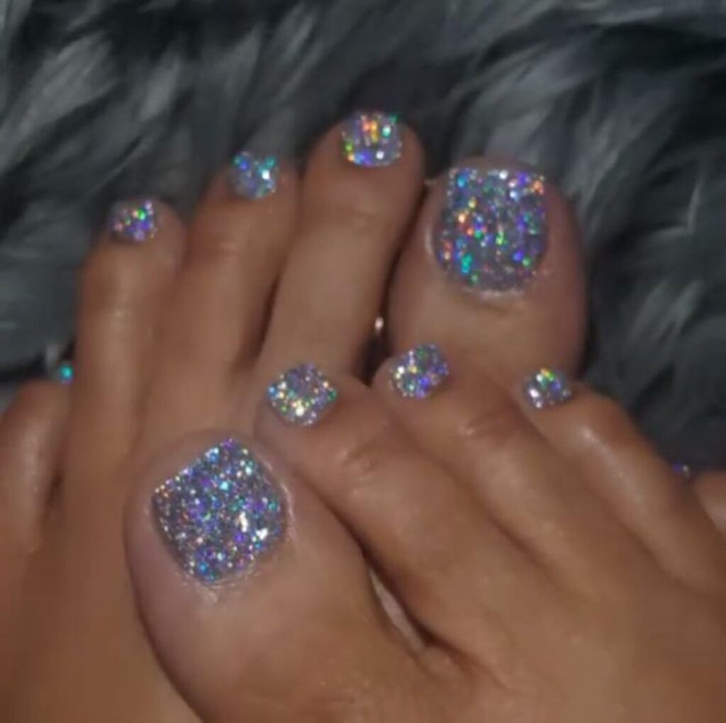 A woman's feet with glitter toe nails
