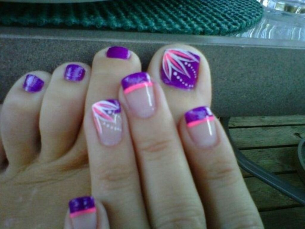 A person with purple and pink nail polish on their nails
