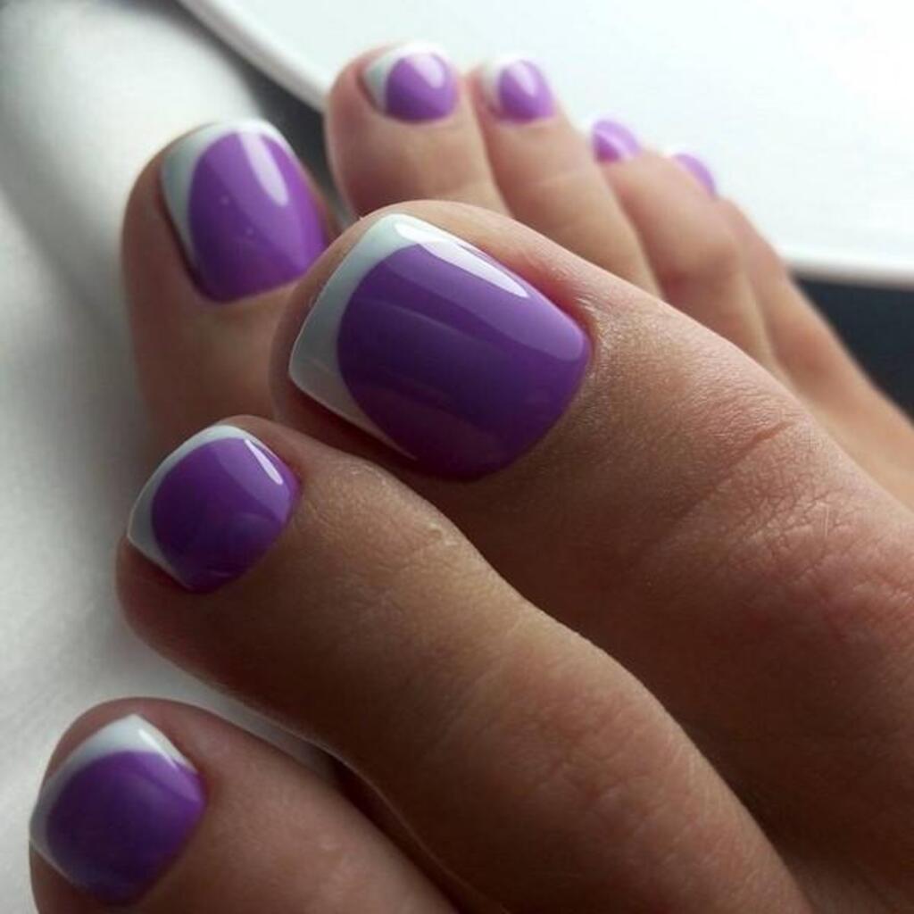 purple and white nail polish on nails
