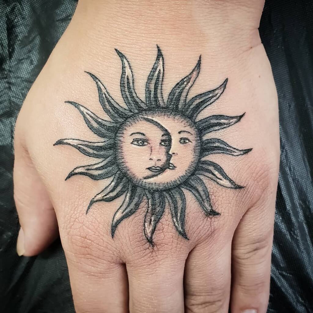 sun and moon tattoo on hand