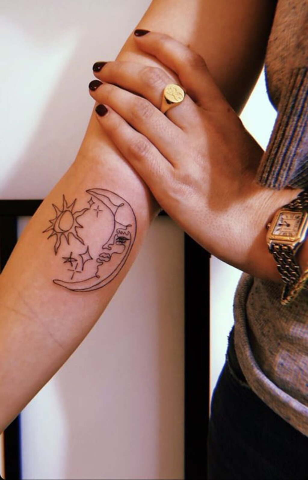 matching sun and moon tattoo on arm for womens