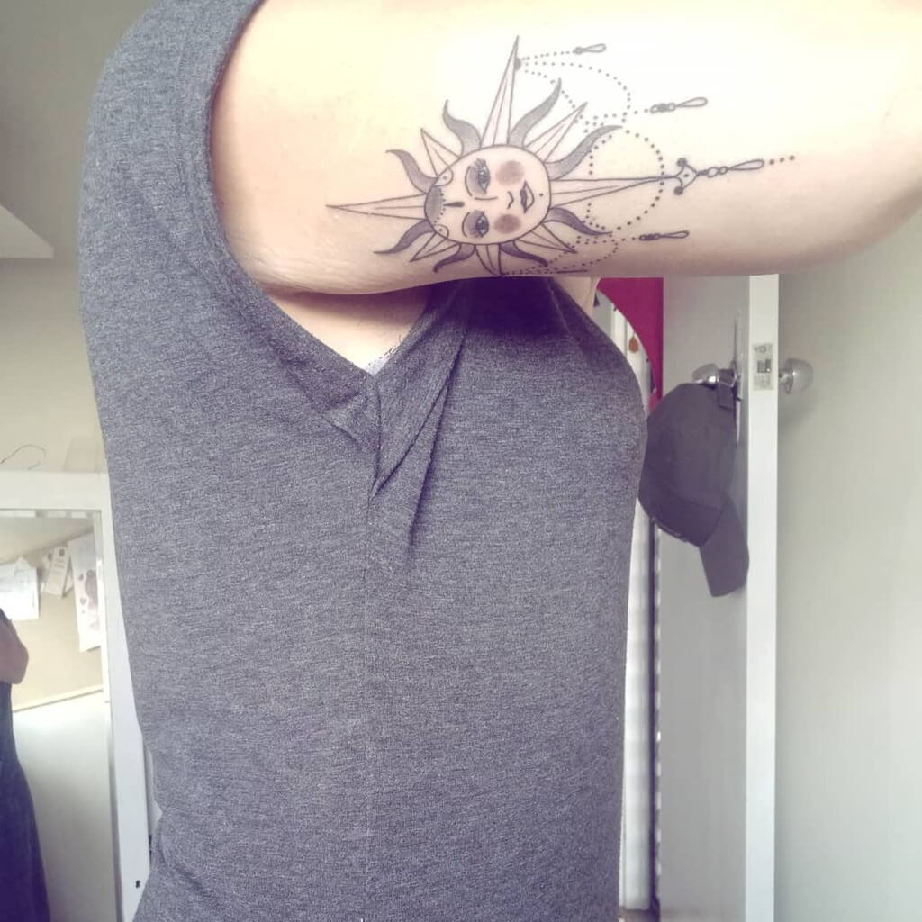 sun and moon tattoo on arm