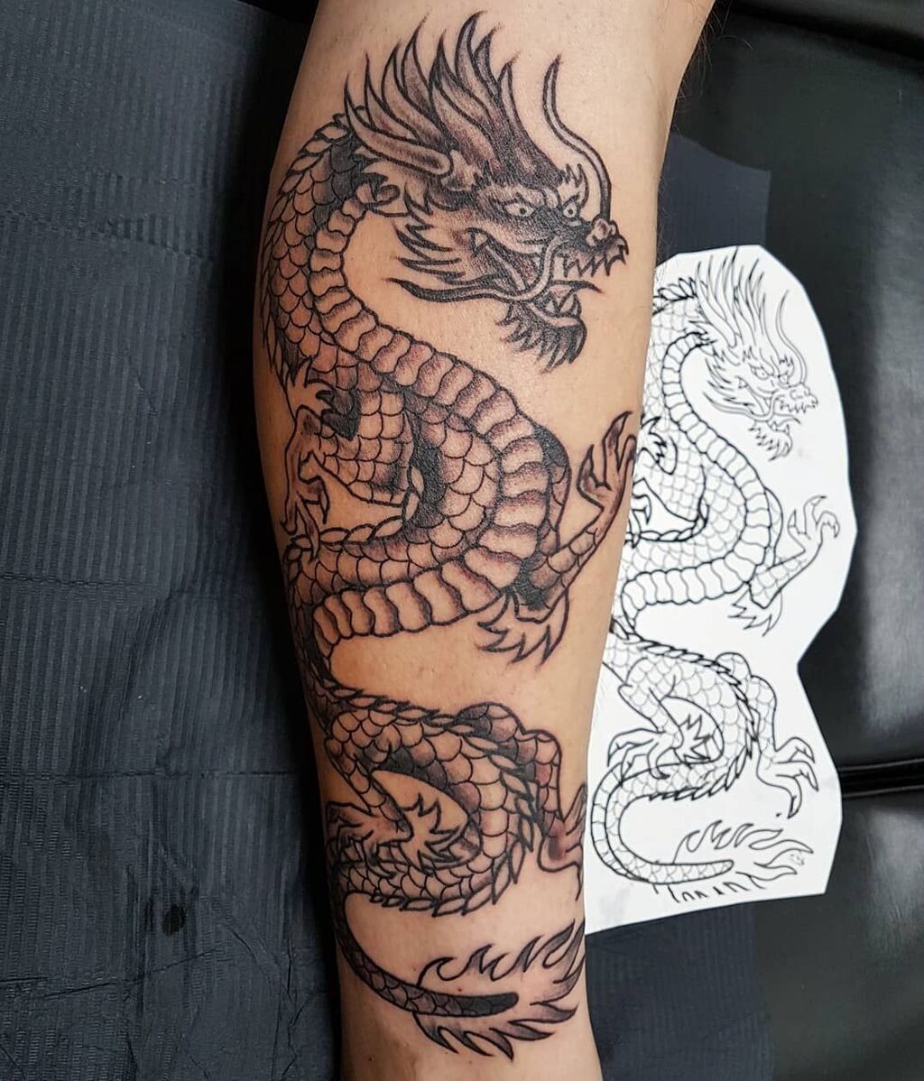A tattoo of a dragon on the arm
