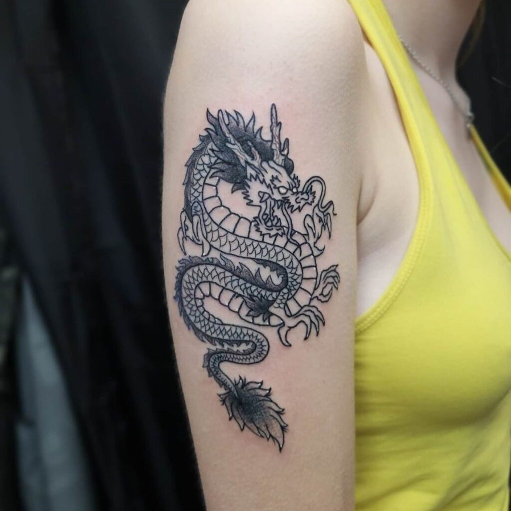 A woman with a dragon tattoo on her arm
