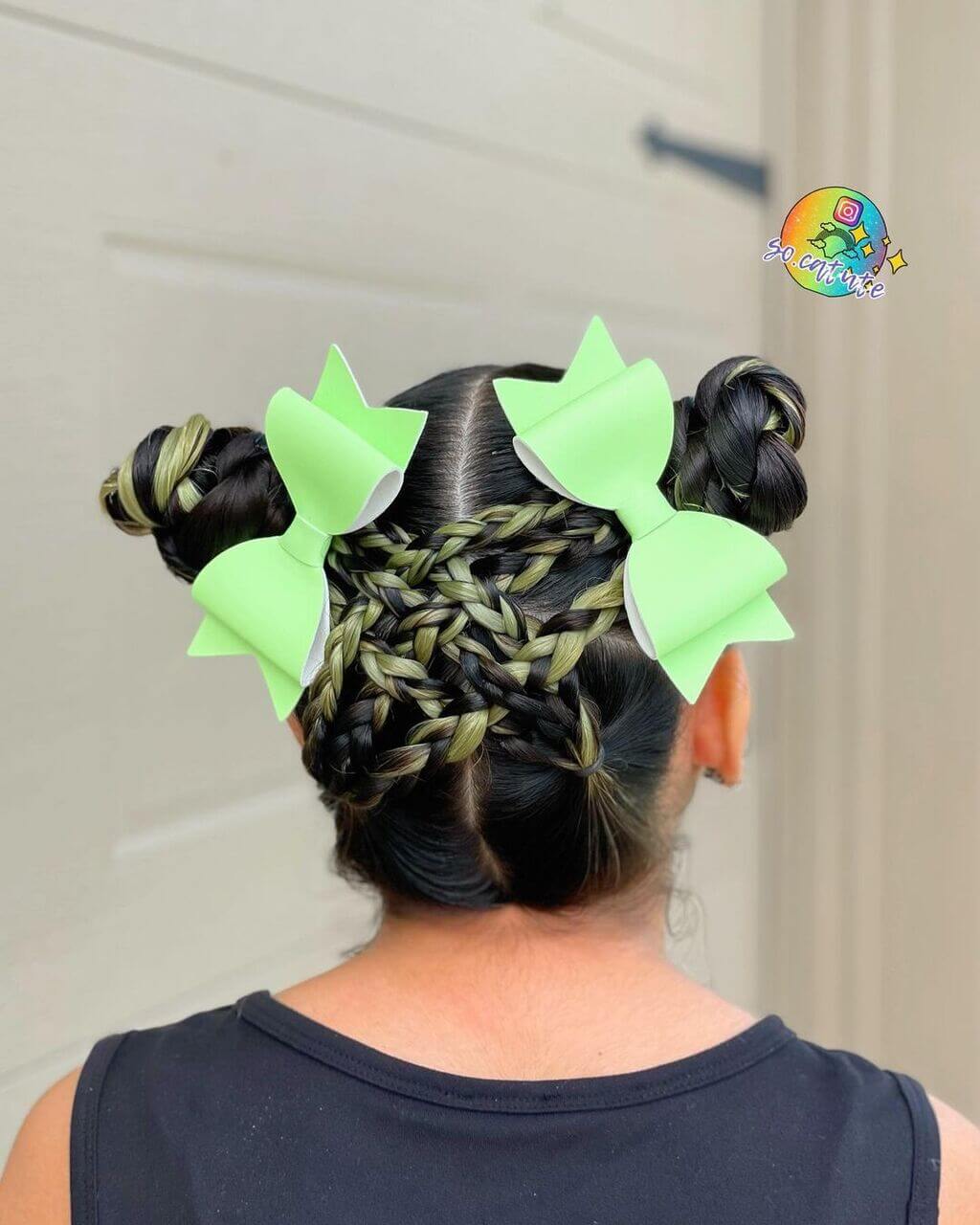A woman with black hair and green bows in her hair
