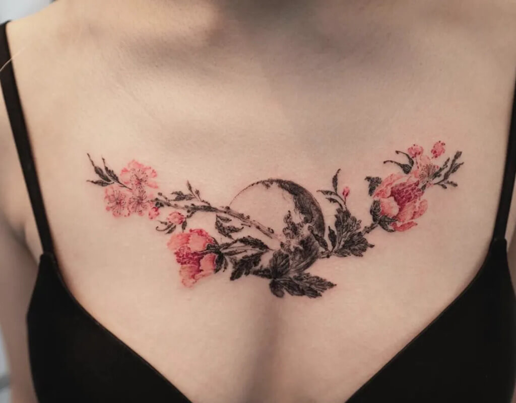 A woman with a tattoo of cherry blossom tree on her chest