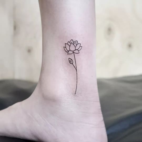 Tattoo of a Lotus Blossom and a Word Stem