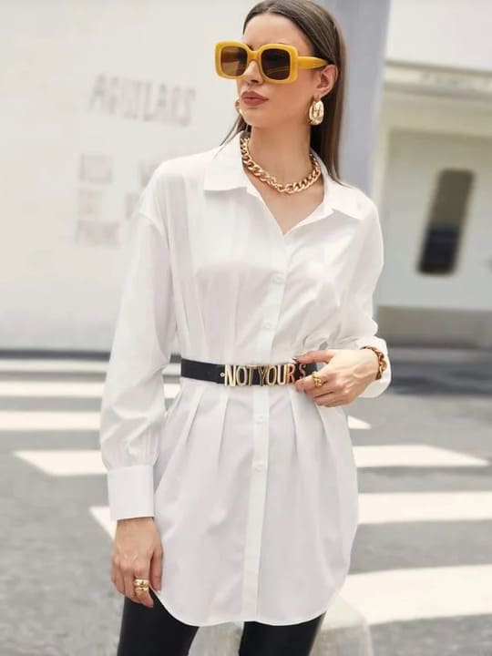 A woman wearing sunglasses and a white shirt
