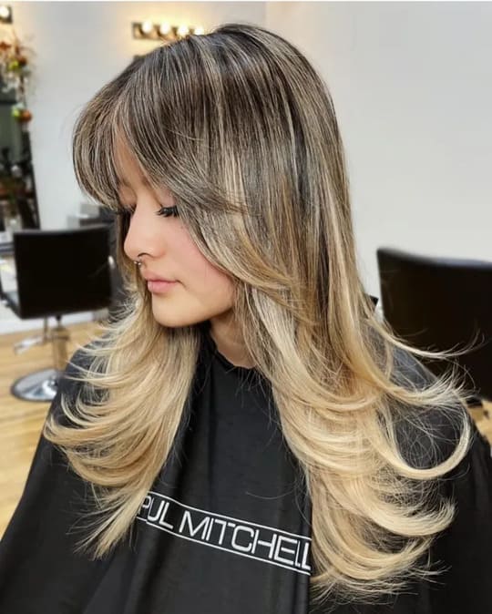 layered blonde hair with curtain bangs