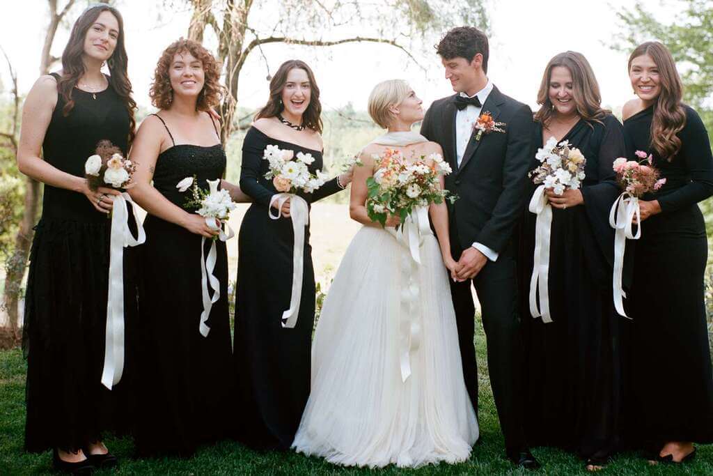 a Groom and bride with their Bridesmaid with black Outfit