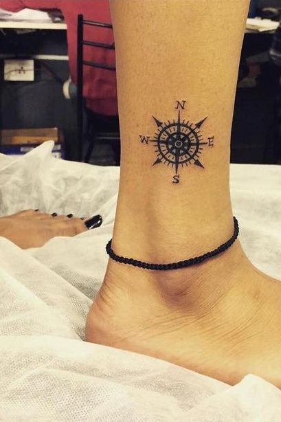 Nautical compass ankle tattoo