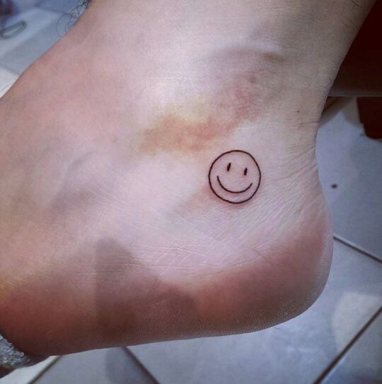Smiley ankle tattoo