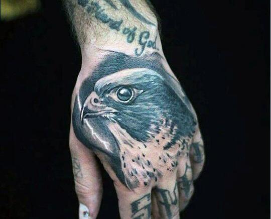 Bird tattoo on hand for men