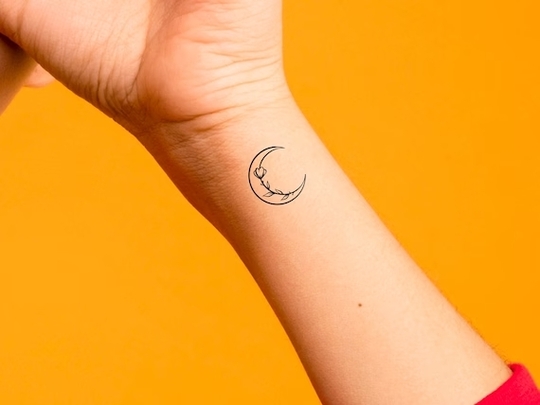 Crescent moon hand tattoo