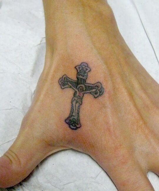 Cross tattoo on hand for men