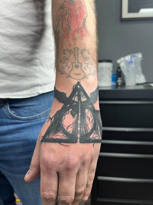 Deathly Hallows tattoo on hand for men