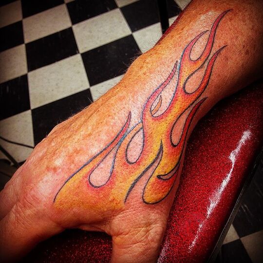 Fiery tattoo on hand for men