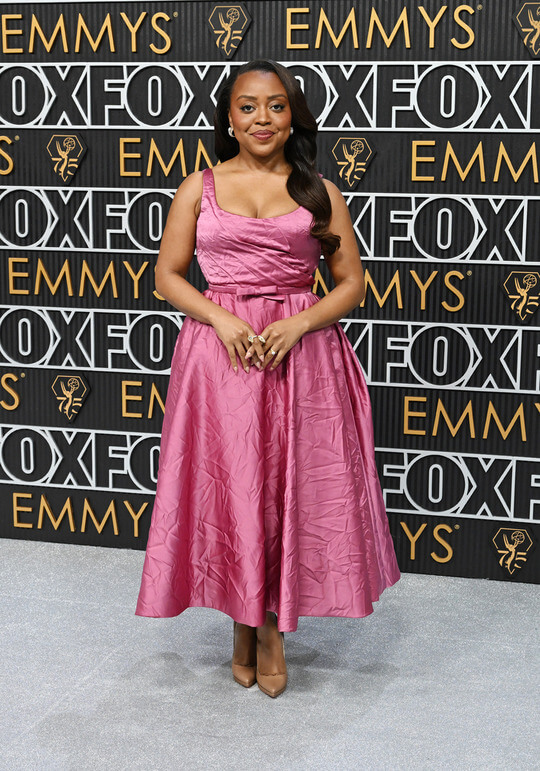 Quinta Brunson in a fuchsia tea length Dress by Christian Dior and Diamond De Beers Jewelry