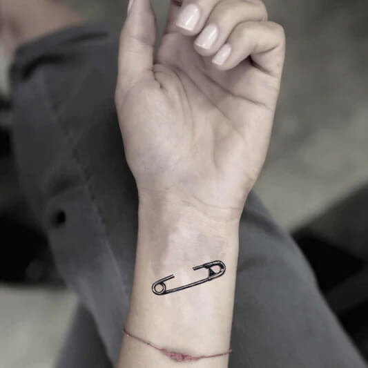 Safety pin hand tattoo