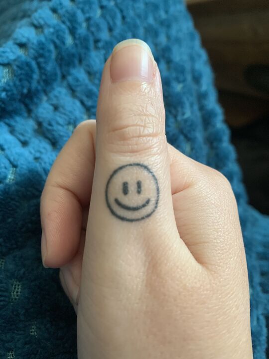 Smiley tattoo on hand