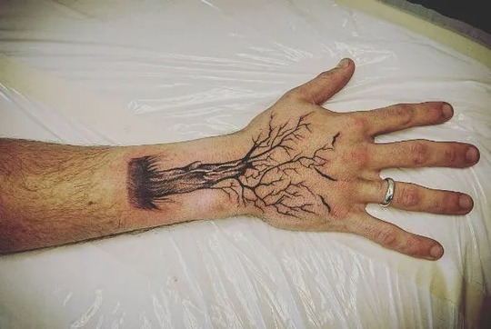 Tree tattoo on hand for men