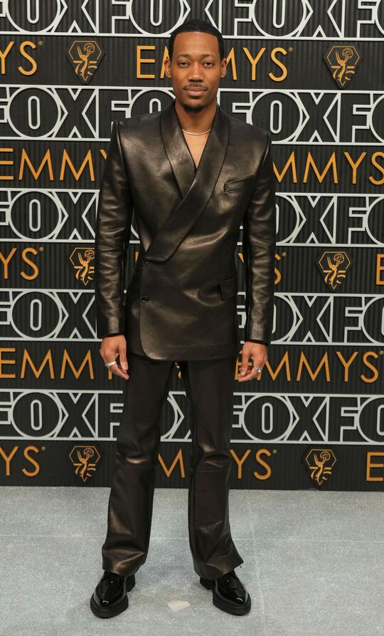 Tyler James Williams in a black leather Dolce & Gabbana suit
