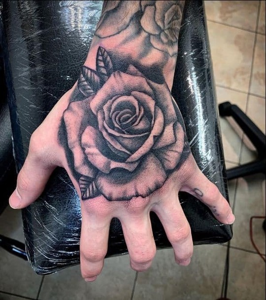 beautiful rose hand tattoo for men